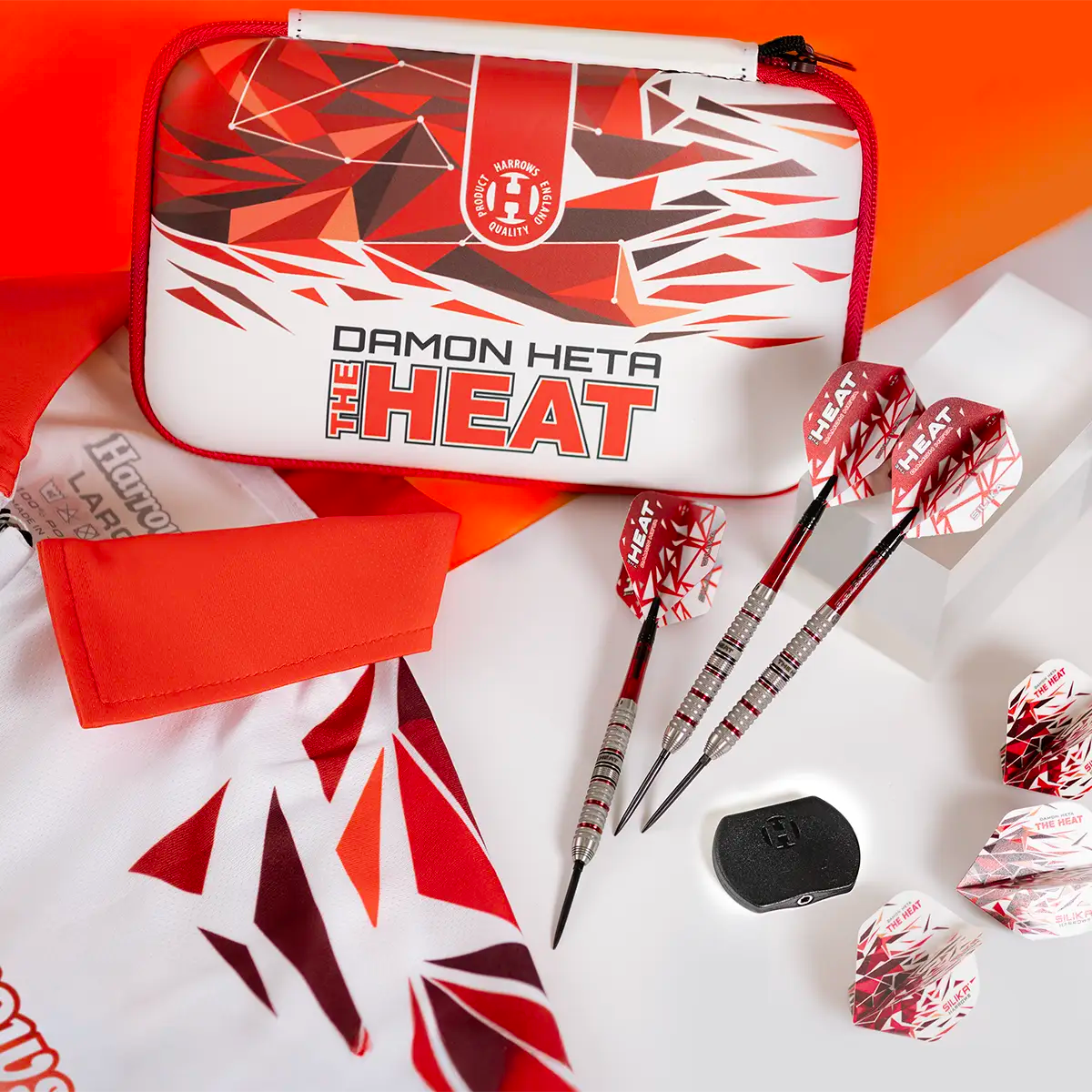 Damon Heta 'The Heat' dart set with case and darts on a colorful background