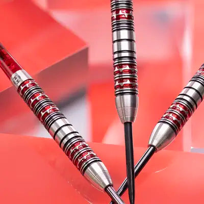Three darts with red and silver design on a red background