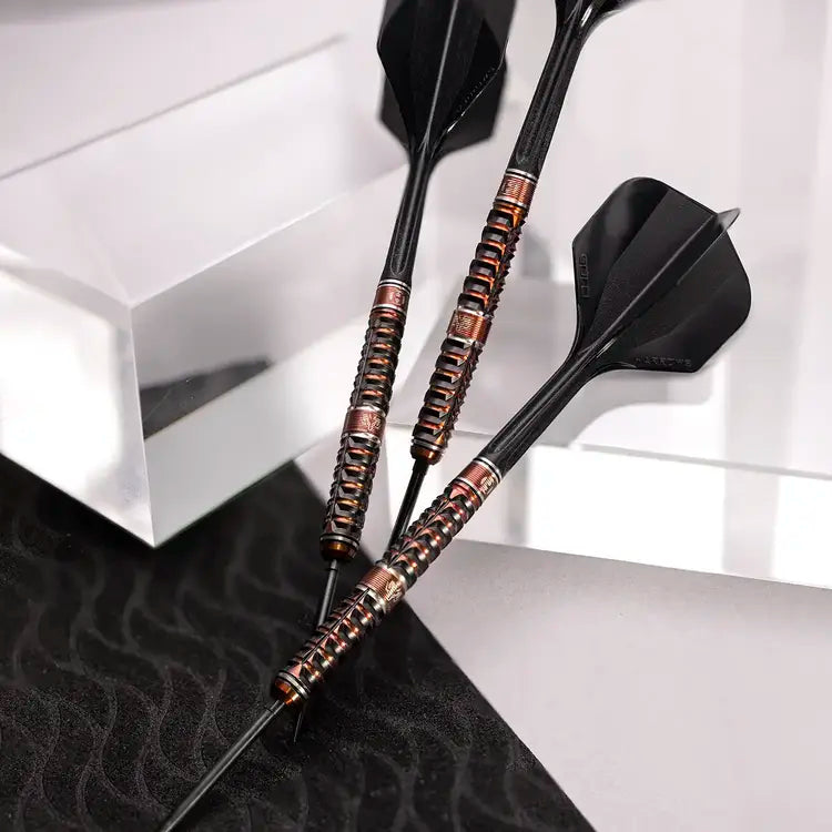 Two darts with black and copper design on a white and black checkered background
